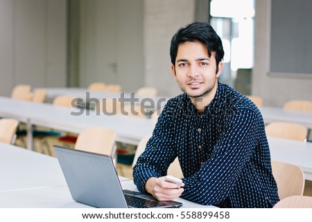 Indian male student with laptop
