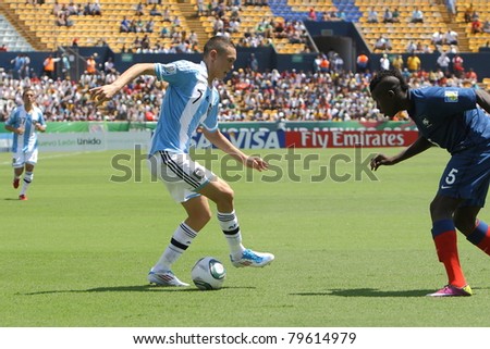 MONTERREY, MEXICO - JUNE 18: Lucas Ocampos (ARG) dribbles against Kurt Zouma (FRA) during FIFA U-17 World Cup Mexico 2011 on June 18, 2011 in Monterrey, Mexico. France won 3 - 0.