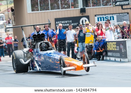 Morrison, CO - June 16, 2013: Car 57 Christine Chambless Alcholol Dragster pops a wheelie at the start line during Thunder on the Mountain presented by Grease Monkey at Bandimere Speedway.