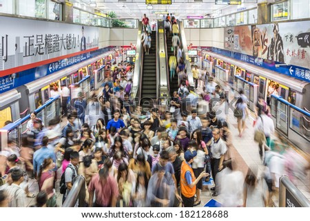 Taipei, Taiwan - July 31: A crowd captured with motion blur rushes in and out of a train in a subway (underground) station in Taipei on July 31 2013.