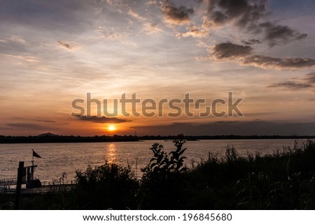 Sunset over the Mekong in Savanakhet in Laos. Here, the river marks the border with Thailand, on the other shore