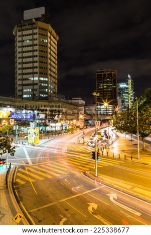 Kuala Lumpur, Malaysia - November 6 2012: Cars rush at night through an intersection in the Kuala Lumpur City Center.