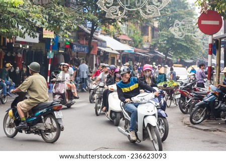 Hanoi, Vietnam - November 5 2014: People drive motorbikes in the very crowded streets of Hanoi old quarter where cars can not easily go.