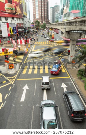 Kuala Lumpur, Malaysia - November 4 2012: Cars rush through the Bukit Bintang intersection in the Kuala Lumpur City Center.