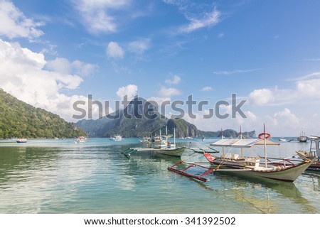 Traditional wooden boats, called banca, wait for tourist to be take around the islands of the Bacuit archipelago near El Nido in Palawan, Philippines.