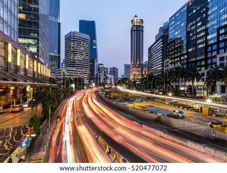 Rush hour traffic in Jakarta business district along the city main avenue, Jalan Sudirman, at night in Indonesia capital city