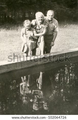 Vintage photo of parents with daughter (fifties)