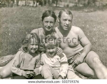 Vintage photo of happy parents with children (eighties)