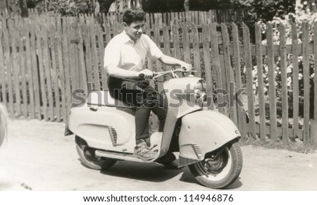 Vintage photo of young man on scooter (sixties)