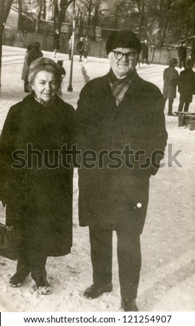 Vintage photo of elderly couple walking (sixties)