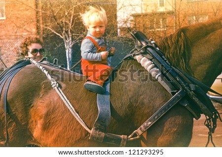 Vintage photo of little boy riding a horse (1983)