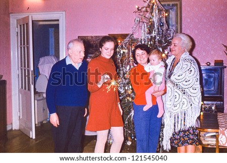 Vintage photo of multigenerational family near Christmas tree (early seventies)