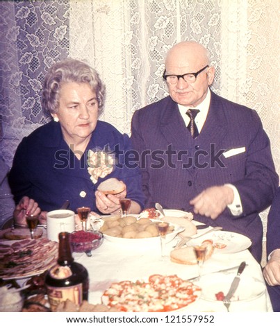 Vintage photo of elderly couple celebrating their anniversary (seventies)