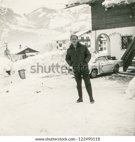 Vintage photo of man in mountain ski resort (fifties)