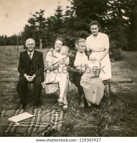 NAMYSLAKI, POLAND -CIRCA 1946: vintage photo of unidentified three generations family with little children, circa 1946 in Namyslaki, Poland
