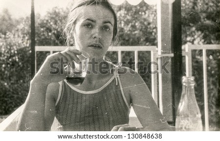 Vintage photo of young girl drinking, sixties