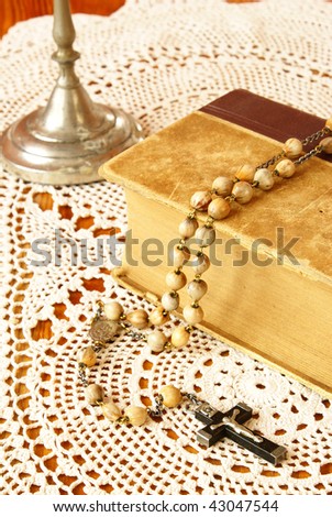 Vintage Bible, rosary beads and candle holder