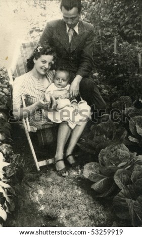 Vintage photo of young parents with their baby (forties)