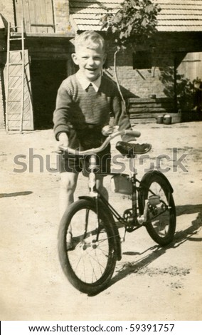 Vintage photo of boy with bicycle (early fifties)