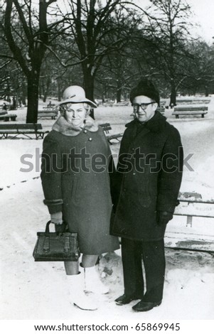 Vintage photo of mature couple in park (winter) -sixties