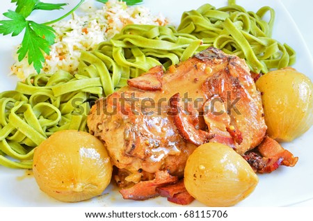 Braised rabbit loin with onion, bacon and mustard, served with spinach tagliatelle and coleslaw salad