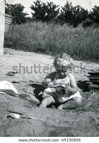 Vintage unretouched photo of little girl plying