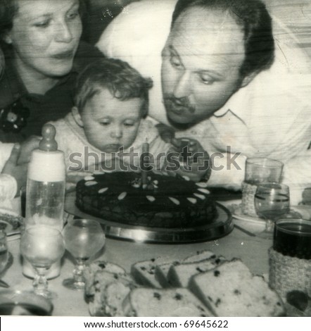 Vintage unretouched photo of parents and daughter (1st birthday)