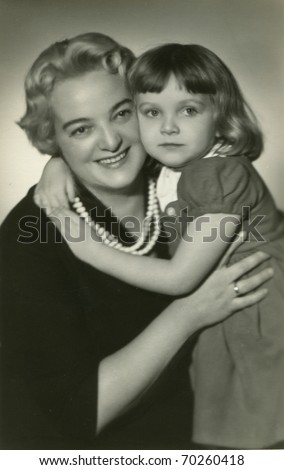 Vintage photo of mother and daughter (visible retouching)