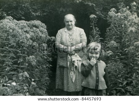 Vintage photo of grandmother with granddaughter (fifties)