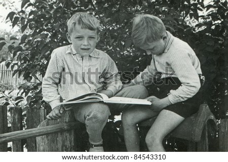 Vintage photo of brothers reading a book (fifties)