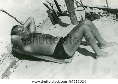 Vintage photo of man on beach  (fifties)
