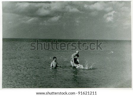 Vintage photo of family bathing in sea (fifties)