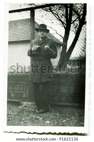 Vintage photo of man with a camera (fifties)