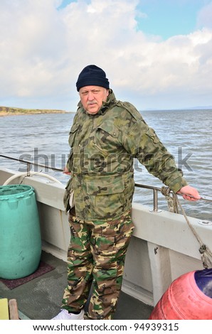Senior  fisherman on boat (deep sea fishing)