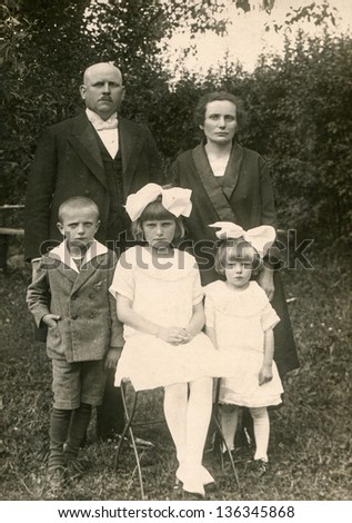LODZ, POLAND, CIRCA 1930 - Vintage photo of unidentified parents with three children in garden, Lodz, Poland, circa 1930