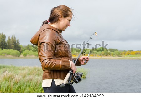 Young fisher-woman with a rode