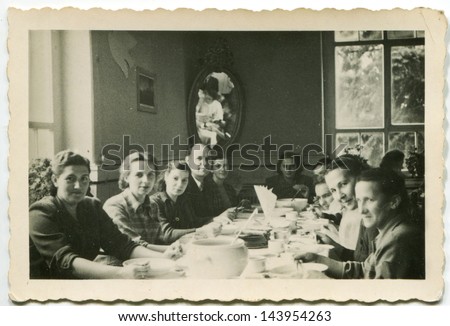 LODZ, POLAND, CIRCA FIFTIES - vintage photo of people enjoying a family dinner, Lodz, Poland, circa fifties