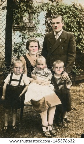 POLAND,, CIRCA THIRTIES - vintage photo of parents with three children (artificially colored), Poland, circa thirties