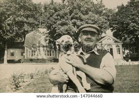 Vintage photo of man with a dog, circa 1950