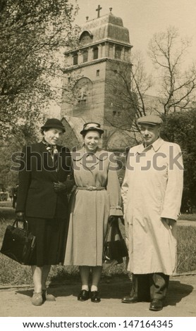 Vintage photo of young woman with her parents, 1953