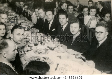 LODZ, POLAND CIRCA FORTIES - vintage photo of group of family and friends parting together, Lodz, Poland circa forties