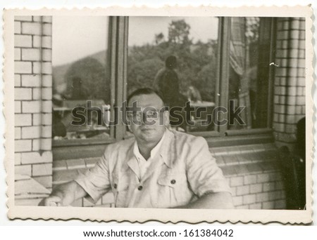 Vintage photo of man on balcony, fifties