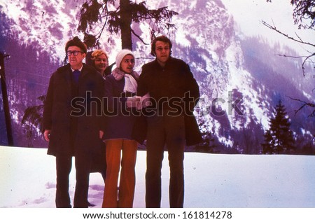 Vintage photo (scanned reversal film) - mature parents with son and daughter-in-law in mountains, seventies