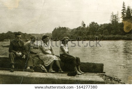 POLAND - CIRCA SIXTIES: vintage photo of family at lakeside, Poland, circa sixties