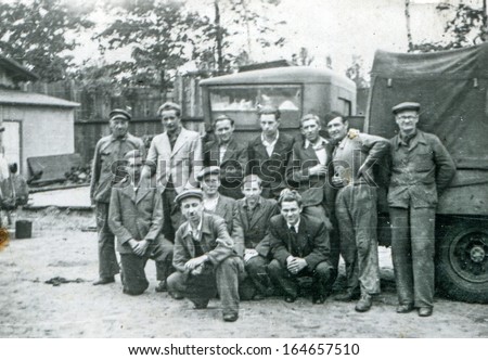 POLAND - CIRCA FORTIES: Vintage photo of group of workers in front of big lorry, Poland, circa forties