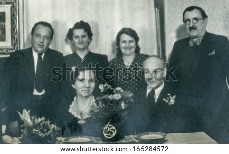 GANSERNDORF, AUSTRIA, CIRCA 1930s: Vintage photo of elderly couple and family at their wedding anniversary, Ganserndorf, Austria, circa 1930s