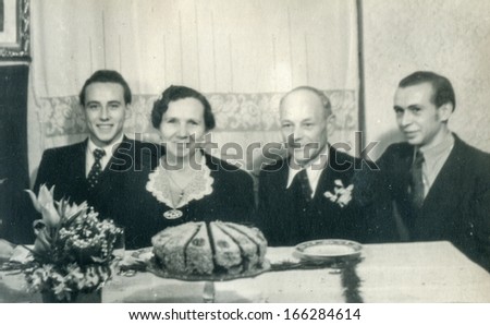 GANSERNDORF, AUSTRIA, CIRCA 1930s: Vintage photo of elderly couple and family at their wedding anniversary, Ganserndorf, Austria, circa 1930s