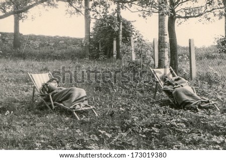 GERMANY, CIRCA FIFTIES - Vintage photo of women resting outdoor in deck chairs