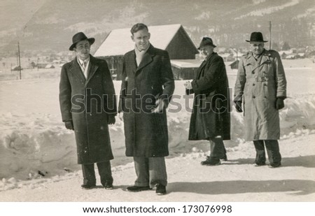 GERMANY, CIRCA FIFTIES - Vintage photo of four men walking in winter