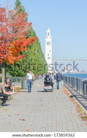 MONTREAL, CANADA, OCTOBER 12, 2013 -  Clock Tower Pier, riverside promenade and St Lawrence River